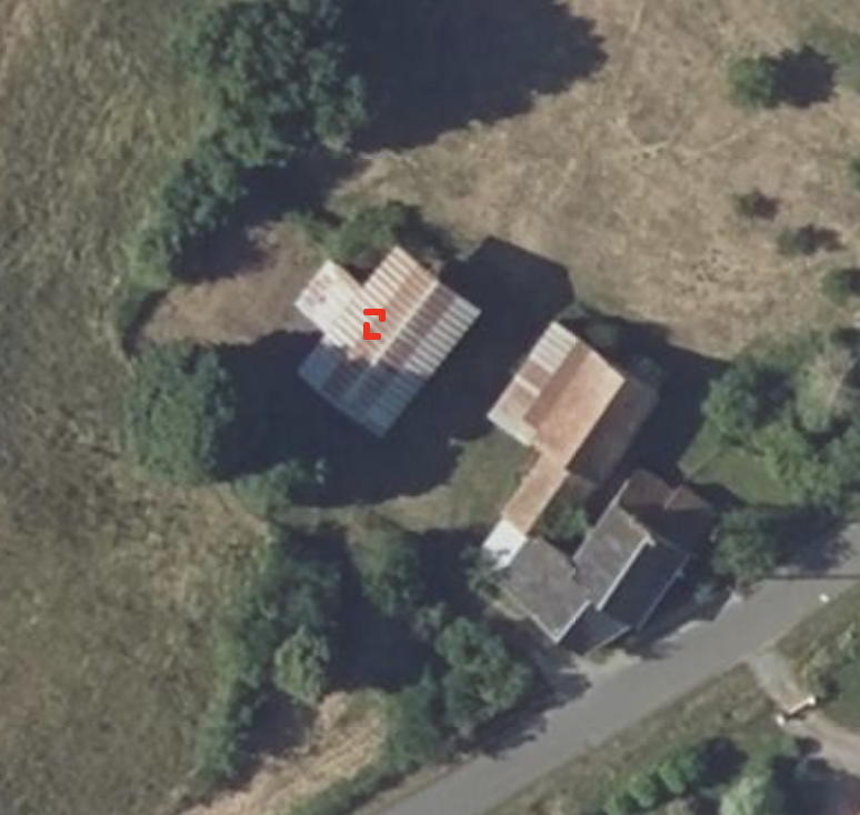 False positive detection on a corrugated farm building roof, flagged as a PV array